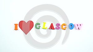I love Glasgow. Text from colorful wooden letters and a beating paper red heart.