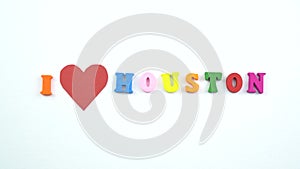 I love Houston. Text from colorful wooden letters and a beating paper red heart.