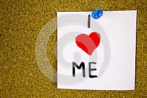 I love me reminder note - handwriting in black ink on an on cork board background.