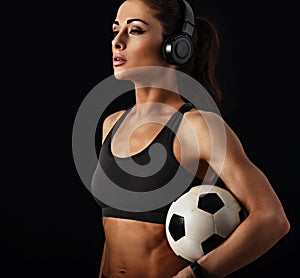 I love my body, fit, mobile, strong, flexible (look description under photo). Sport woman holding ball in headphones