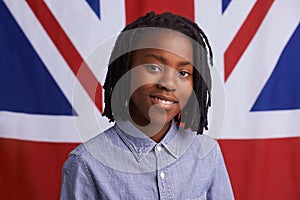 I love my country. Portrait of a happy young boy standing in front of the Union Jack.