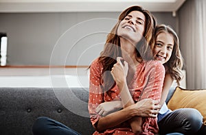 I love my mommy. an attractive young woman and her daughter hugging while spending time together at home.