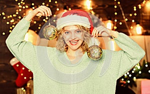 I love new year. Cheerful woman. decorate the Christmas tree. winter holidays decorations. girl in red santa claus hat