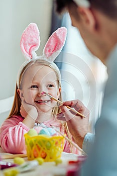 I love preparing for Easter with my dad.Dad and his little daughter together have fun while preparing for Easter holidays