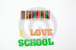I love school , School supplies colored pencils in a row, isolated