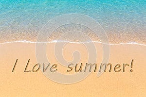 I love summer written in a sandy tropical beach.