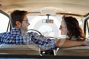 I love taking roadtrips with you. Rearview shot of an affectionate couple enjoying a summer road trip.