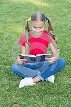 I love to read. Happy reader summer outdoors. Little child read book on green grass. Summer reading list. Fantasy and