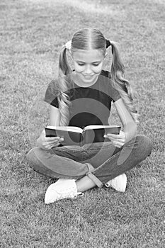 I love to read. Happy reader summer outdoors. Little child read book on green grass. Summer reading list. Fantasy and