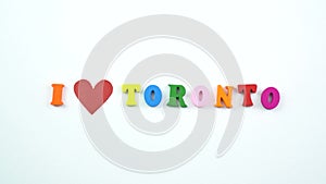 I love Toronto. Text from colorful wooden letters and a beating paper red heart.