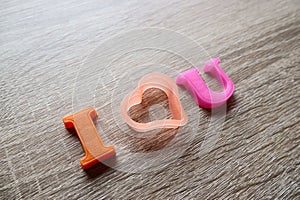 `i love u` word Close-up shot selective focus colorful, magnetic letters with romantic question for Valentine`s Day