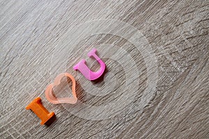 `i love u` word Close-up shot selective focus colorful, magnetic letters with romantic question for Valentine`s Day