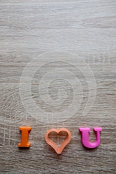 `i love u` word Close-up shot selective focus colorful, magnetic letters with romantic question for Valentine`s Day