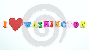 I love Washington. Text from colorful wooden letters and a beating paper red heart.