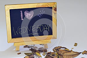 I love Wednesday written on a chalkboard. Autumn seasonal flat lay photo on White background