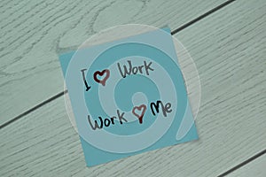I Love Work and Work Love Me write on sticky notes isolated on Wooden Table