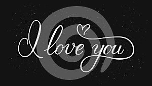 I love you calligraphy hand lettering with heart on black background. Valentines day greeting card. Romantic typography poster.