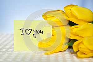 I love you, card with words and yellow tulips flowers