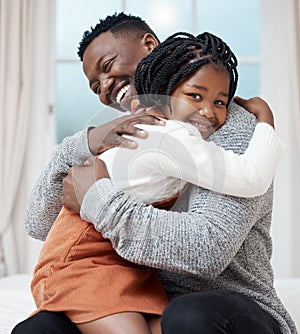 I love you Dad. Shot of a young father hugging his daughter while bonding at home.