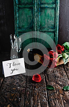 I love you greeting card, red roses and champagne bottle with glasses