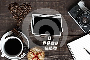 I love you inscription with coffee cup, retro camera blank photo and notebook