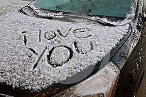 I Love You message on car hood after a snow