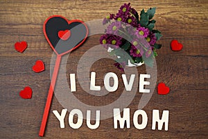 I love you mom wording on old wood mother`s day concept.