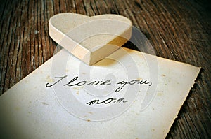 I love you, mom written on an old sheet of paper, with a retro e