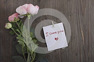 I love you note with pink roses on a wooden table,valentines day