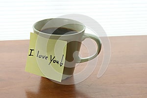 I love You! note on steaming cup of coffee in morning light