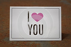 I Love You Printed Card Laying on The Metal Background