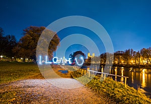 I love you sign in the middle of a river with bright night sky