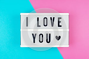 I Love You - text on a display lightbox on blue and pink