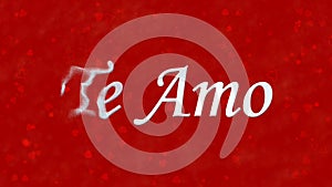 I Love You text in Portuguese and Spanish Te Amo turns to dust from left on red background