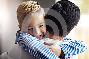 I love you tons, Dad. an adorable little boy hugging his father at home.