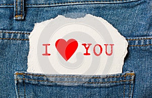 I love you on torn paper background on jeans love and valentine concept