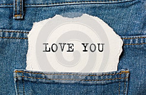 I love you on torn paper background on jeans love and valentine concept