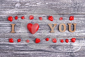 I love you, wooden lettering, gray background, postcard Happy Valentine day, flat lay