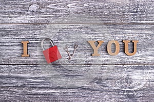 I love you, wooden lettering, gray background, postcard Happy Valentine day, flat lay