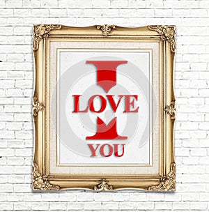 I love you word in golden vintage photo frame on white brick wall,Love concept