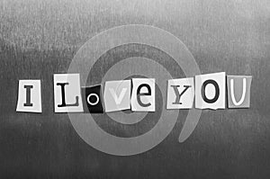 I Love You written with color magazine letter clippings on metal background. Design for relationships, romance, love and