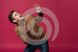 I`m afraid. Fright. Portrait of the scared man on trendy pink studio background. Male half-length portrait