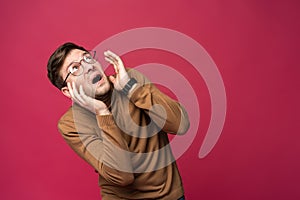 I`m afraid. Fright. Portrait of the scared man on trendy pink studio background. Male half-length portrait