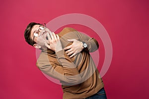 I`m afraid. Fright. Portrait of the scared man on trendy pink studio background. Male half-length portrait