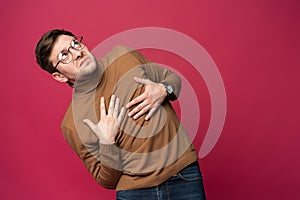 I`m afraid. Fright. Portrait of the scared man on trendy pink studio background. Male half-length portrait