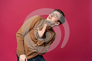 I`m afraid. Fright. Portrait of the scared man on trendy pink studio background. Male half-length portrait