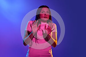 I& x27;m afraid. Fright. Portrait of the scared woman. Business woman standing isolated on trendy neon studio background