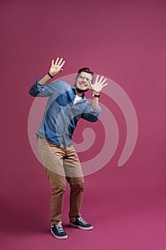 I`m afraid. Fright. Scared man. Business man standing isolated on trendy pink studio background. Human emotions, facial