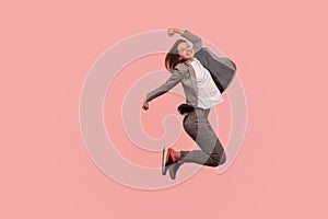 I`m champion! Portrait of enthusiastic ecstatic happy businesswoman in elegant suit jumping carefree in air