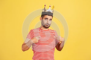 I`m king! Ambitious bearded man wearing golden crown and pointing himself, looking with arrogance, declaring his authority,